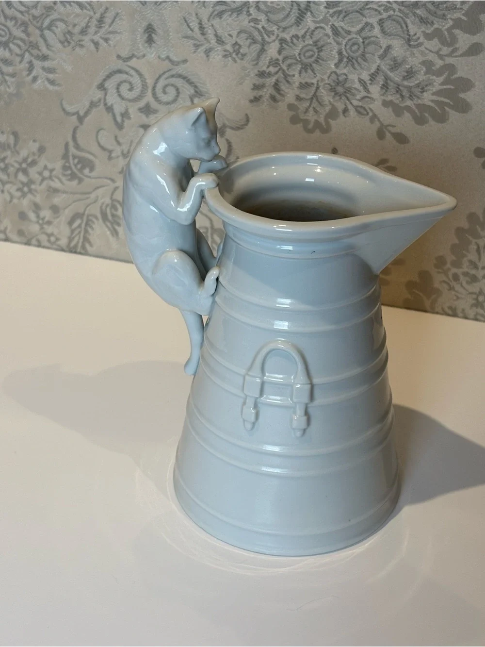 Vintage White Porcelain pitcher with a cat as a handle. Holds 20oz.
